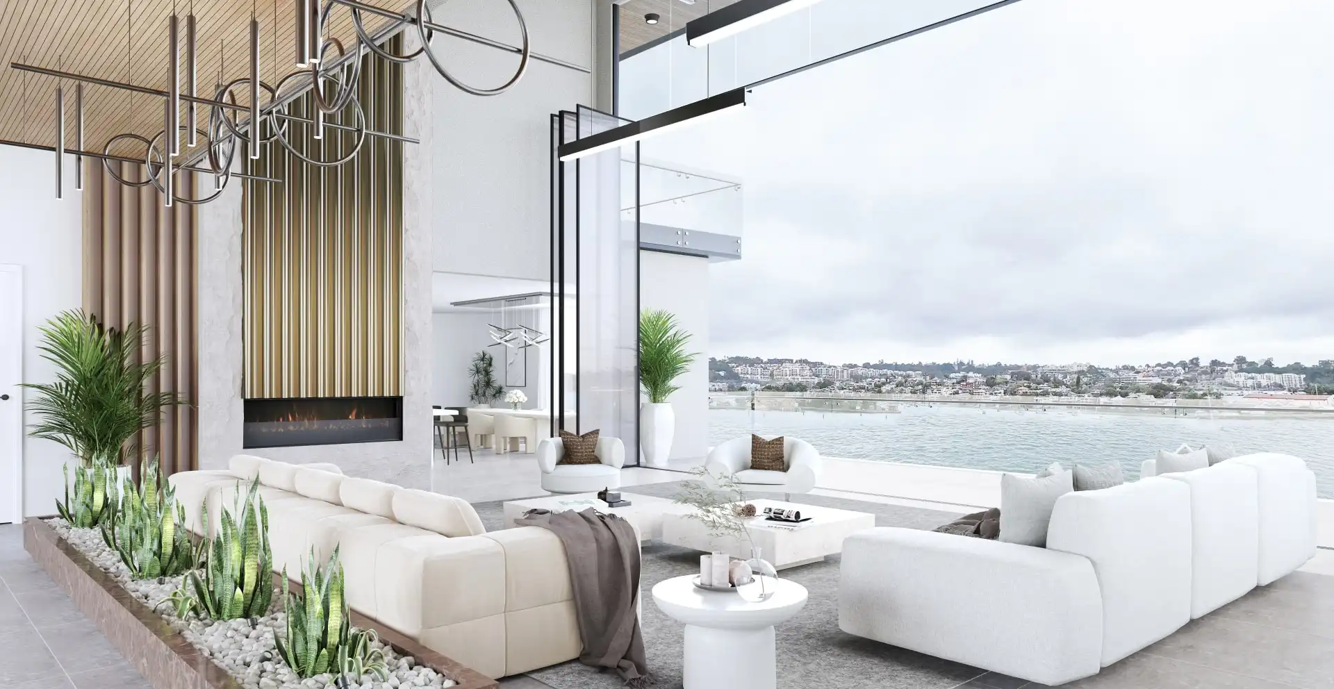 Double-height living room open to the water, with a fireplace and sculptural pendant